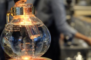 Siphon Brewer at Blue Bottle Coffee Aoyama Tokyo with Barista in background