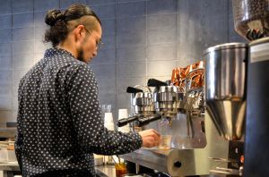 Barista prepares espresso at The Roaster by Nozy Coffee Jingumae Tokyo Japan