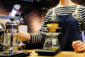 Barista preparing a pour-over at The Roaster by Nozy Coffee Jingumae Tokyo Japan