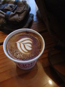 Latte art in a paper cup at No. 8 Bear Pond Espresso Shibuya Tokyo Japan