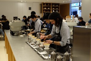Barista preparing a pour over at Blue Bottle Coffee Shinjuku Tokyo Japan