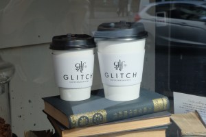 Paper coffee cups on Japanese book at Glitch Coffee and Roasters in Jimbocho Tokyo Japan