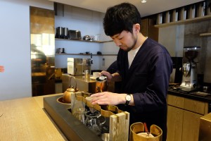 Barista with copper kettle at Cobi Coffee in Aoyama Tokyo Japan