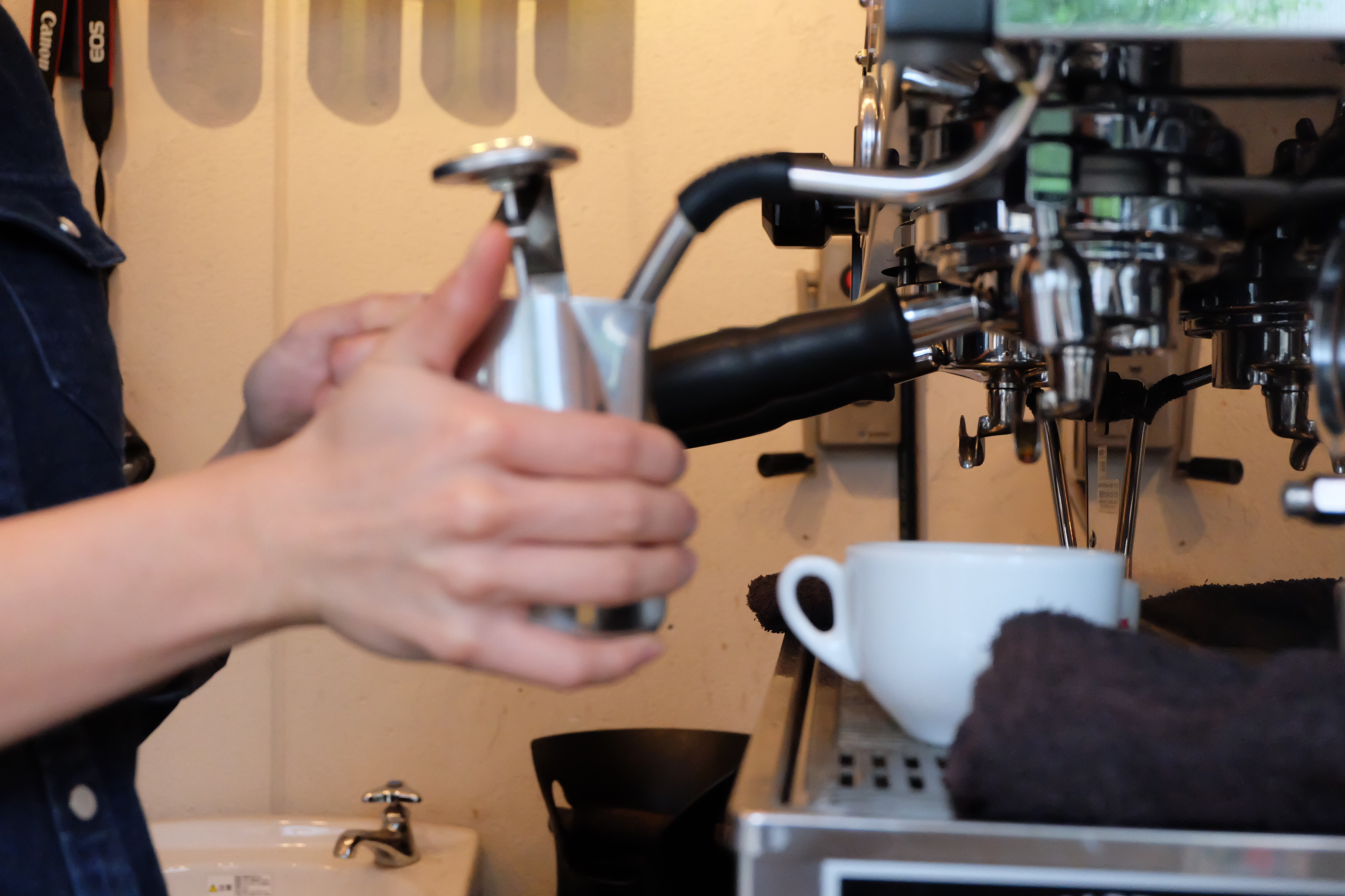 Barista making latte at Counterpart Coffee Gallery Nishi Shinjuku Tokyo Japan