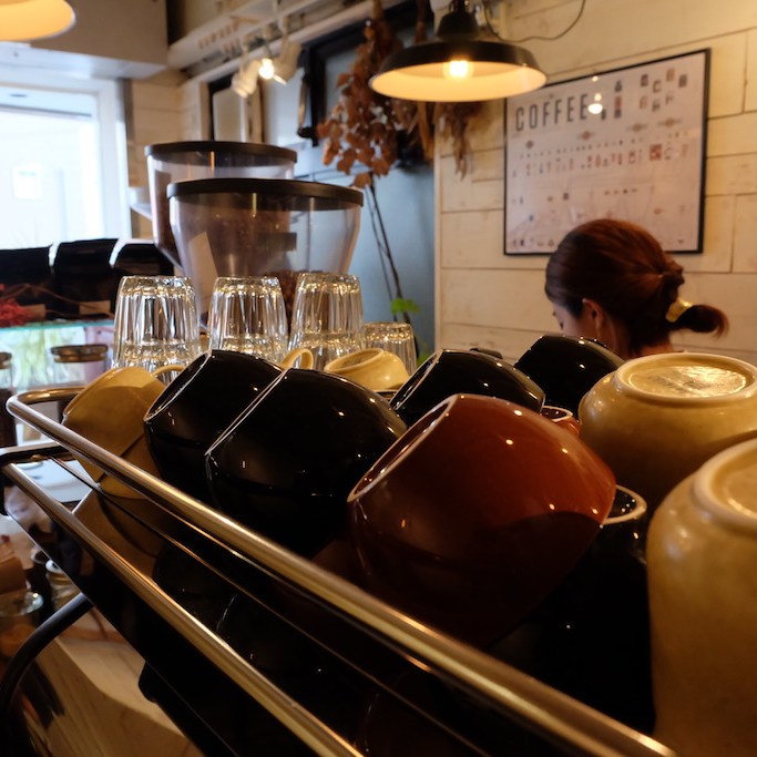Up close coffee cups on espresso machine at Onibus Okusawa Tokyo Japan