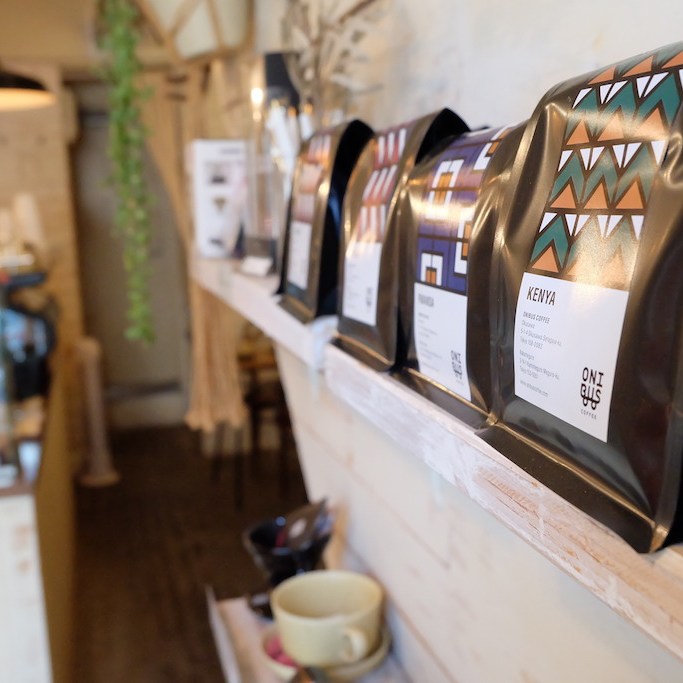 Coffee bags lined on a shelf at Onibus Coffee Okusawa Tokyo Japan