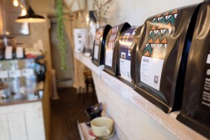 Coffee bags lined on a shelf at Onibus Coffee Okusawa Tokyo Japan